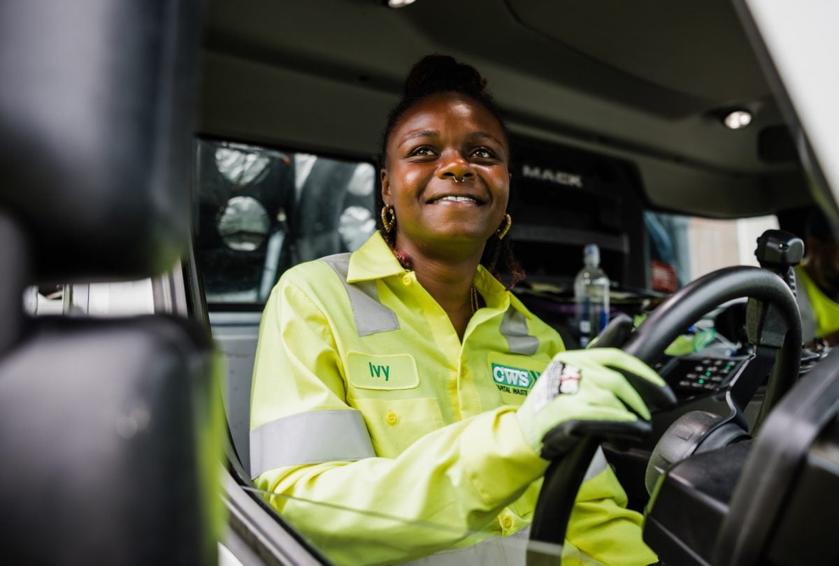 Smiling CWS employee driving collection truck